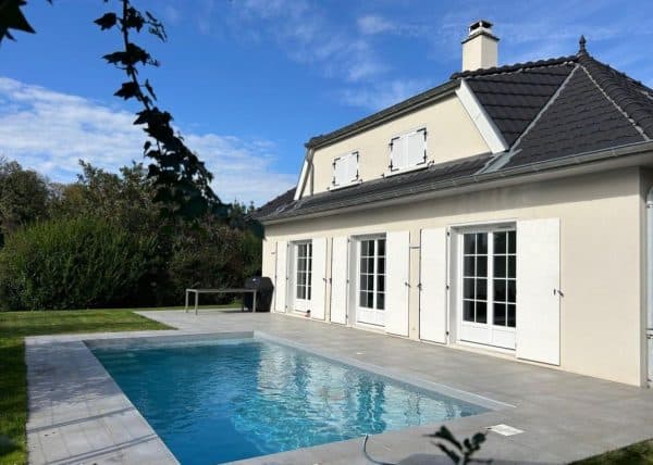 piscine coque SUZANE devant maison de maitre. La marque COLETTE